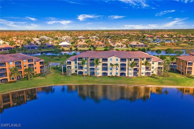 drone / aerial view featuring a residential view and a water view