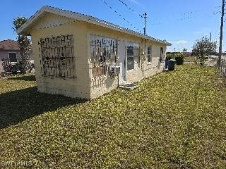 view of side of home with a yard