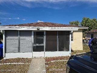 view of side of property featuring a sunroom