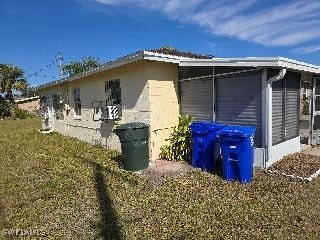 view of side of property with a lawn