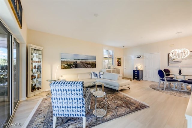 living area featuring a chandelier and wood finished floors