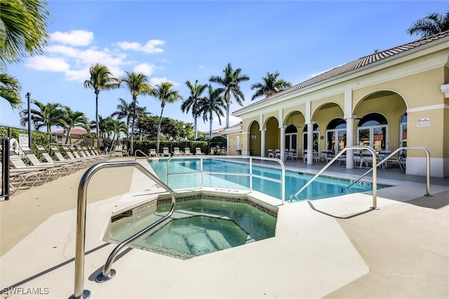 pool featuring a community hot tub and a patio