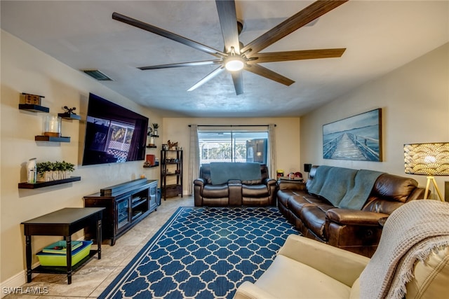 living room with baseboards, visible vents, a ceiling fan, and light tile patterned flooring