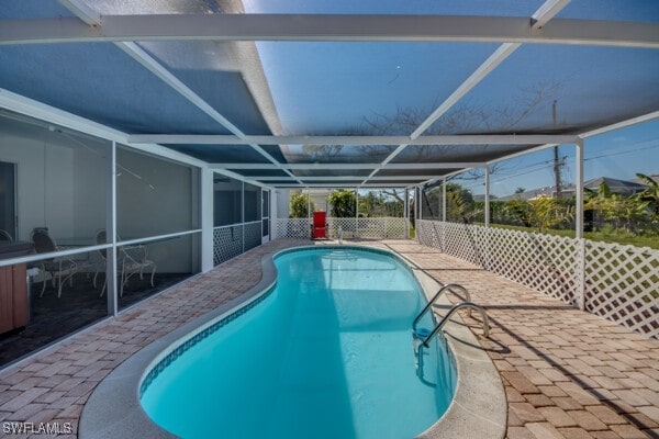 outdoor pool with a patio area and a lanai