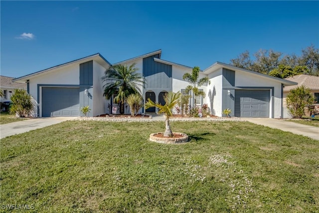 mid-century home featuring a garage, driveway, and a front yard