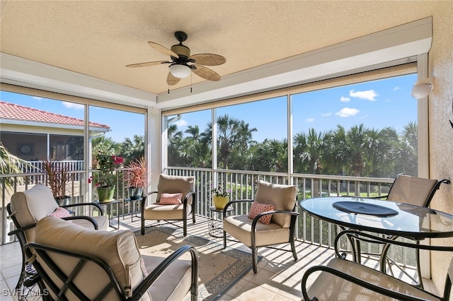 sunroom / solarium with plenty of natural light and ceiling fan