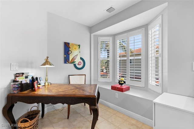 office space with visible vents, baseboards, and light tile patterned flooring