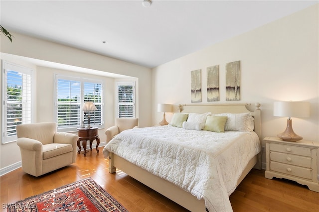 bedroom featuring baseboards and wood finished floors