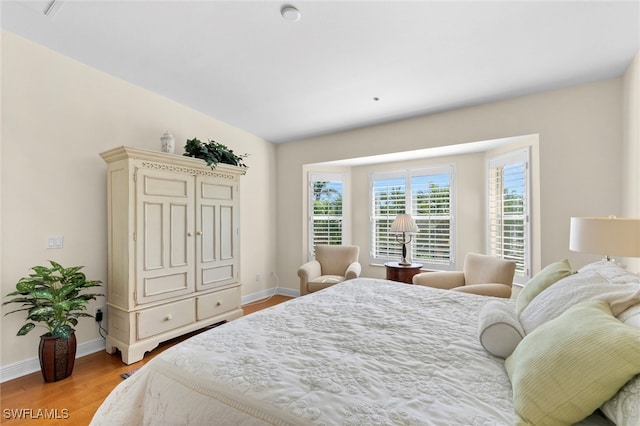 bedroom with baseboards and light wood finished floors