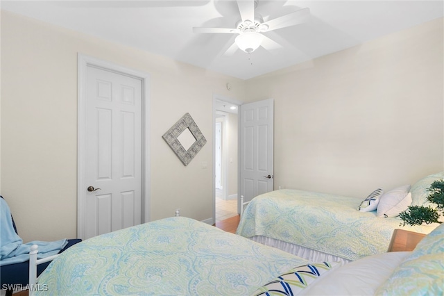 bedroom featuring a ceiling fan and baseboards