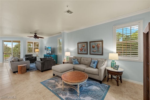 living area featuring a wealth of natural light, visible vents, crown molding, and baseboards