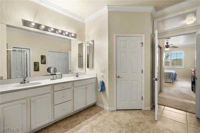 ensuite bathroom featuring crown molding, double vanity, connected bathroom, a sink, and tile patterned flooring