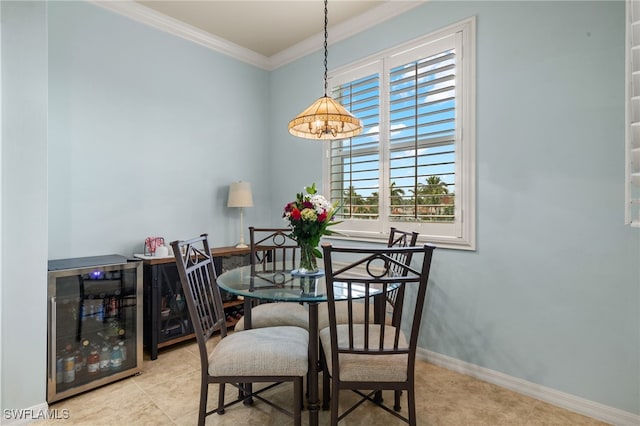 dining space with wine cooler, light tile patterned floors, ornamental molding, a chandelier, and baseboards