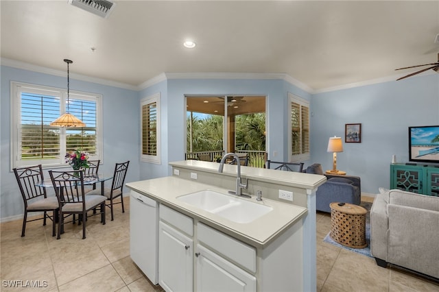 kitchen featuring a sink, white cabinets, light countertops, dishwasher, and decorative light fixtures