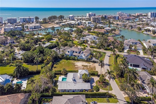 birds eye view of property with a view of city and a water view