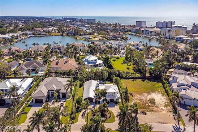 birds eye view of property with a residential view and a water view