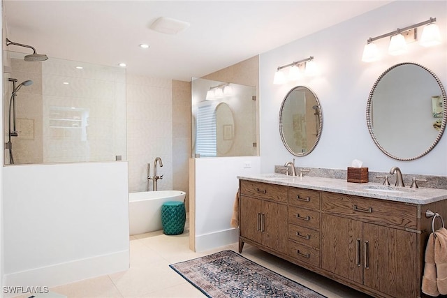 bathroom featuring a freestanding tub, a walk in shower, a sink, and tile patterned floors