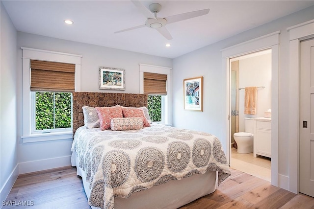 bedroom with light wood-type flooring, ensuite bath, and recessed lighting