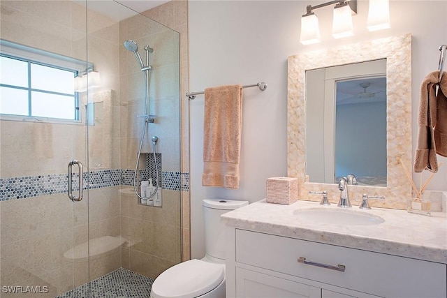 bathroom featuring a stall shower, vanity, and toilet