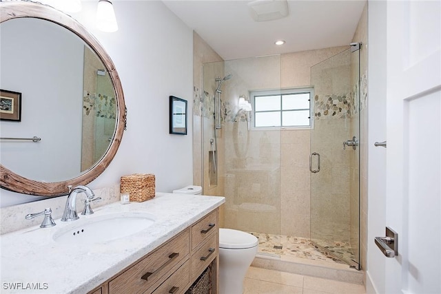 full bathroom featuring vanity, a shower stall, toilet, and tile patterned floors