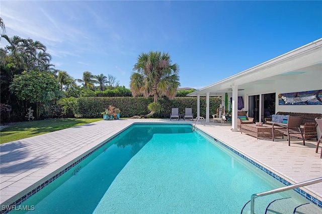 view of pool with a patio, outdoor lounge area, and a fenced in pool