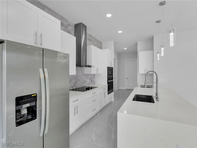 kitchen with black electric stovetop, white cabinetry, hanging light fixtures, stainless steel refrigerator with ice dispenser, and wall chimney exhaust hood