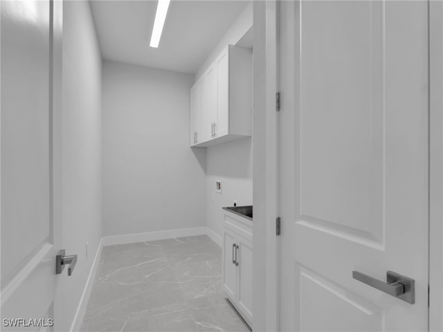 laundry area featuring hookup for a washing machine, hookup for an electric dryer, baseboards, marble finish floor, and cabinet space