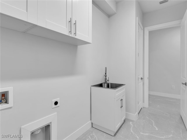 laundry room featuring marble finish floor, hookup for a washing machine, cabinet space, a sink, and electric dryer hookup