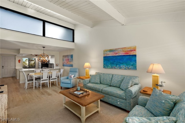 living area featuring light wood-style floors, wood ceiling, a chandelier, and beamed ceiling