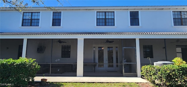 back of property with ceiling fan, french doors, cooling unit, and a sunroom