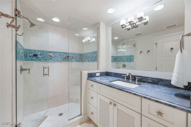 bathroom featuring visible vents, a shower stall, and vanity