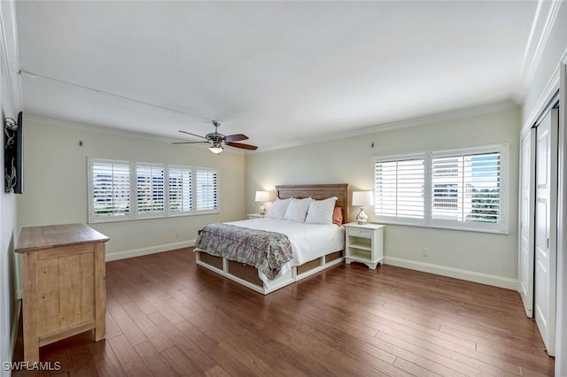 bedroom with ceiling fan, dark wood-style flooring, baseboards, a closet, and crown molding