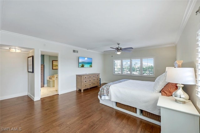 bedroom featuring visible vents, crown molding, baseboards, and wood finished floors