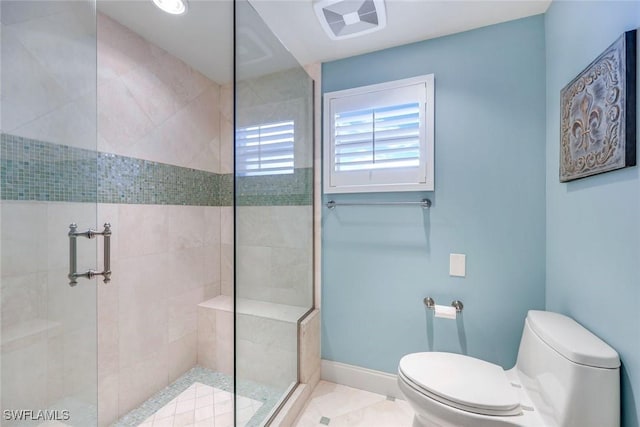 bathroom with a stall shower, baseboards, visible vents, and toilet