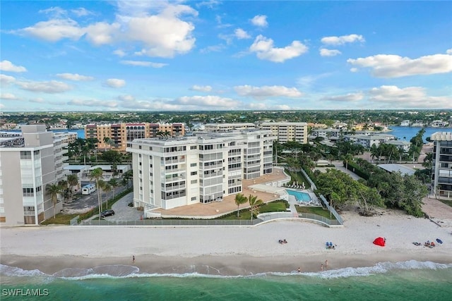 bird's eye view with a water view, a view of the beach, and a city view