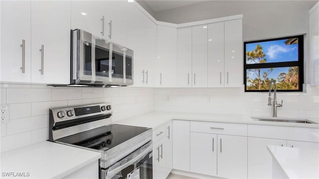 kitchen featuring a sink, modern cabinets, white cabinetry, and stainless steel appliances