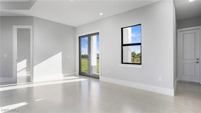 unfurnished room featuring recessed lighting and baseboards