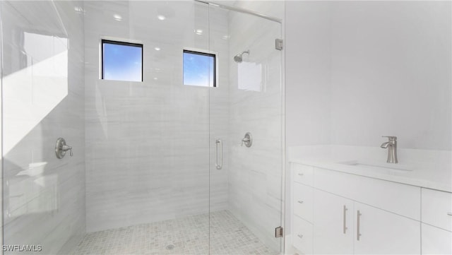 bathroom featuring a shower stall and a sink