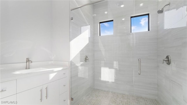 full bathroom with a stall shower and vanity