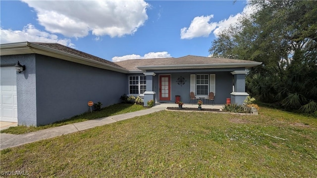 view of front of home with an attached garage, a front yard, a porch, and stucco siding