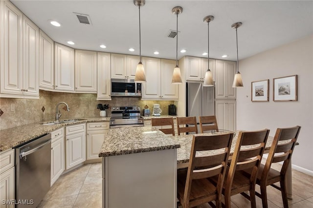 845 E Gulf Dr Unit 232, Sanibel, FL 33957 - kitchen featuring light tile patterned floors, visible vents, a sink, stainless steel appliances, and backsplash