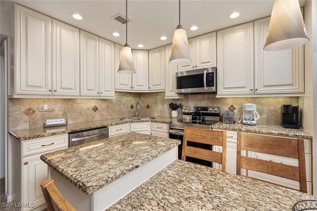 845 E Gulf Dr Unit 232, Sanibel, FL 33957 - kitchen with light stone counters, stainless steel appliances, visible vents, decorative backsplash, and a sink