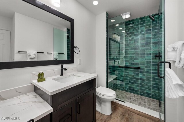 845 E Gulf Dr Unit 232, Sanibel, FL 33957 - bathroom featuring recessed lighting, toilet, vanity, a shower stall, and wood finished floors