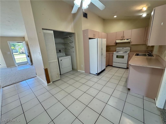 kitchen featuring light countertops, visible vents, washer / dryer, white appliances, and under cabinet range hood