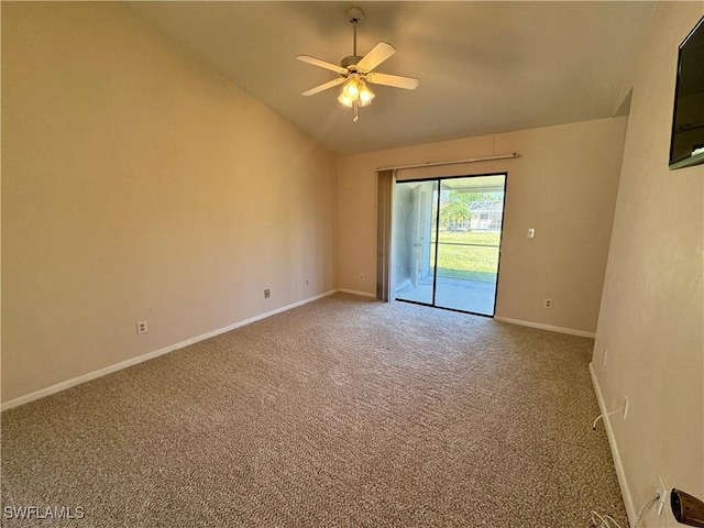 carpeted spare room with vaulted ceiling, baseboards, and ceiling fan