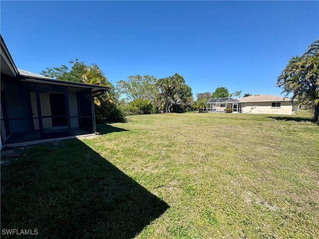 view of yard with a lanai