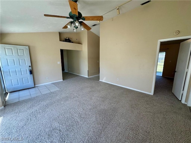 carpeted spare room with ceiling fan, high vaulted ceiling, tile patterned flooring, and baseboards