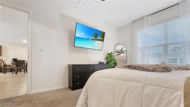 bedroom with light carpet and baseboards