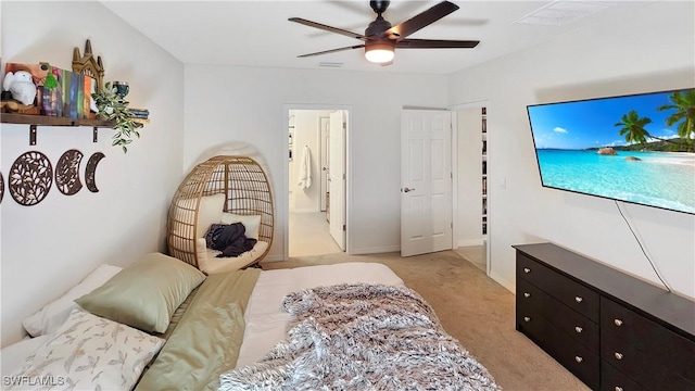 bedroom featuring light carpet, baseboards, a ceiling fan, and ensuite bathroom