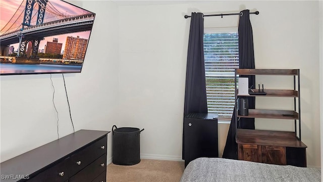 bedroom with light carpet and baseboards